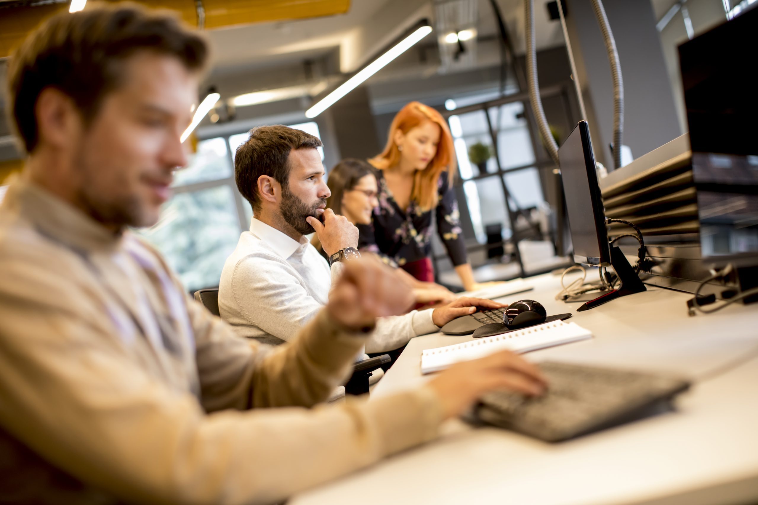 Young professional businessman uses a computer for work in the o